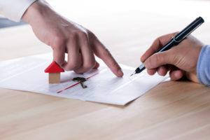 New homeowner signing contract of house sale or mortgage papers